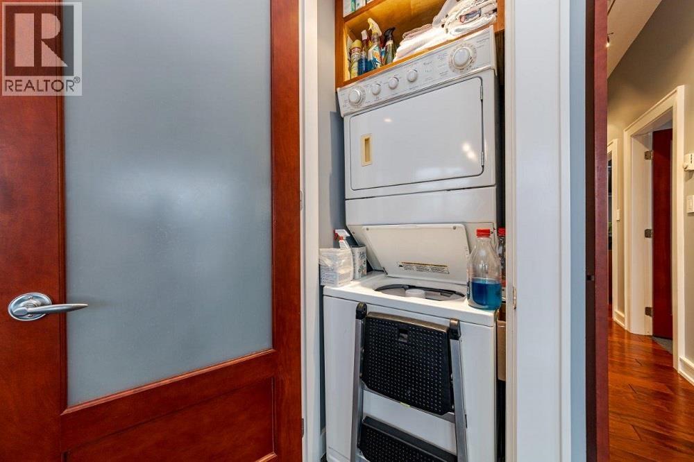 A white oven is built into a kitchen cabinet.