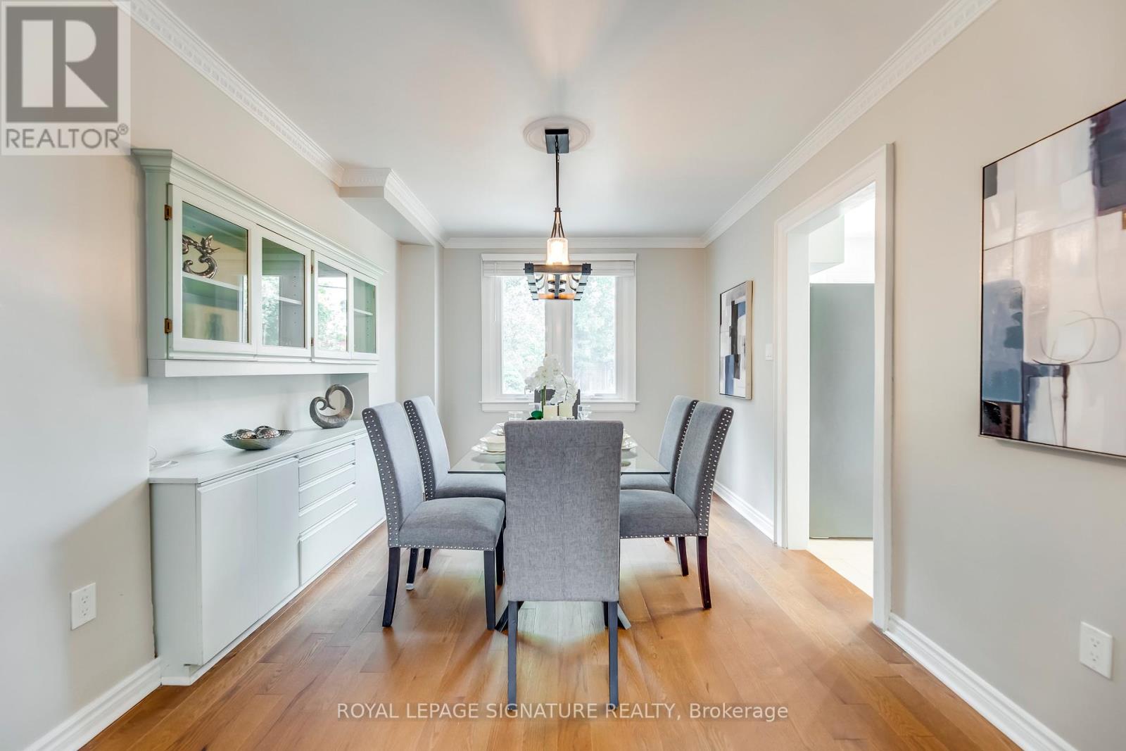 A dining room with a table set for four.