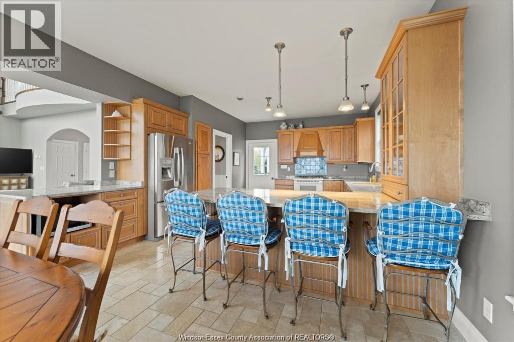 A kitchen with a table and chairs.