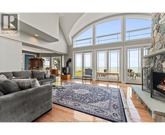 A living room with a grey couch and a fireplace.