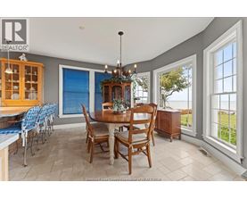 A dining room with a table set for six.