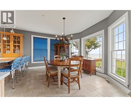 A dining room with a table set for six.