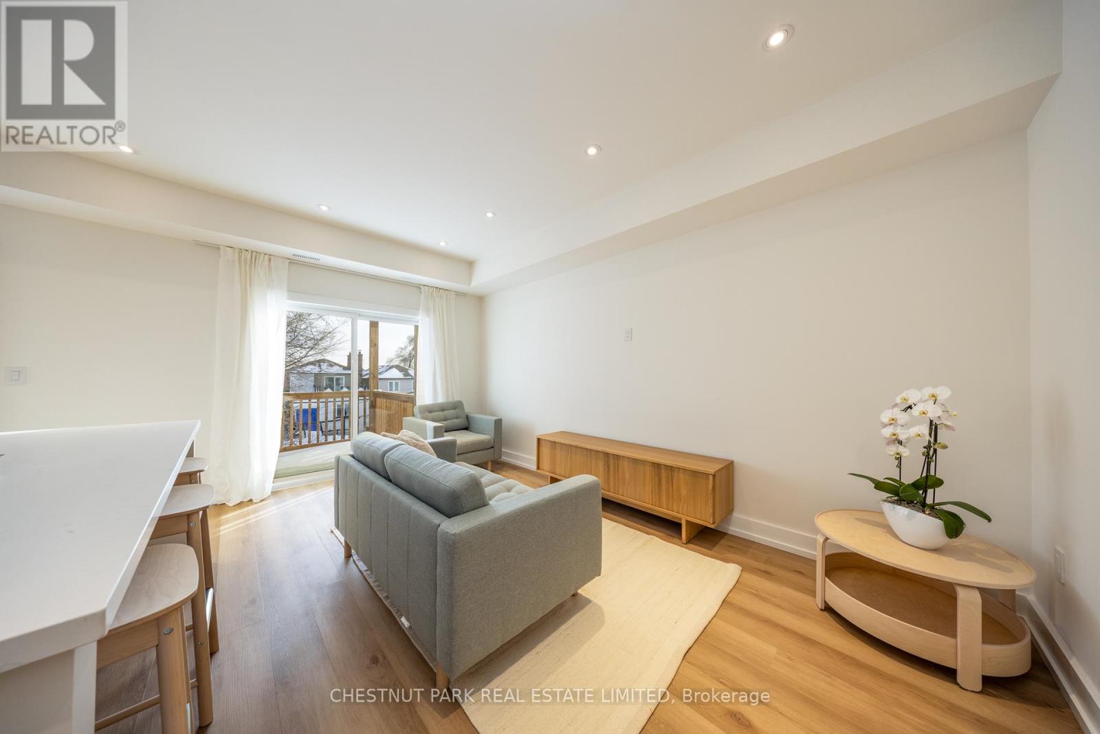 A living room with a grey couch and a wooden coffee table.