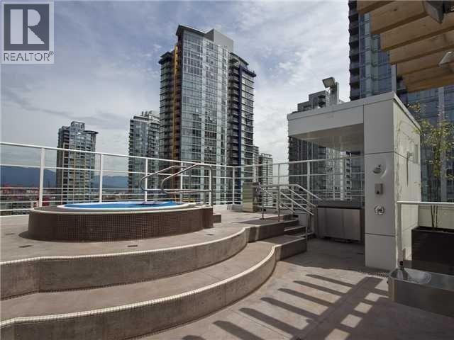 A modern building with a pool in the foreground and a glass facade.