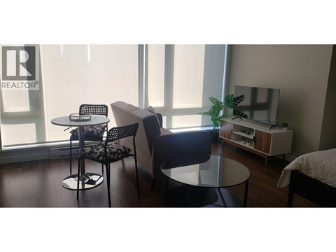 A living room with a table and chairs.