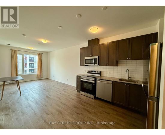 A kitchen with wooden cabinets and a refrigerator.