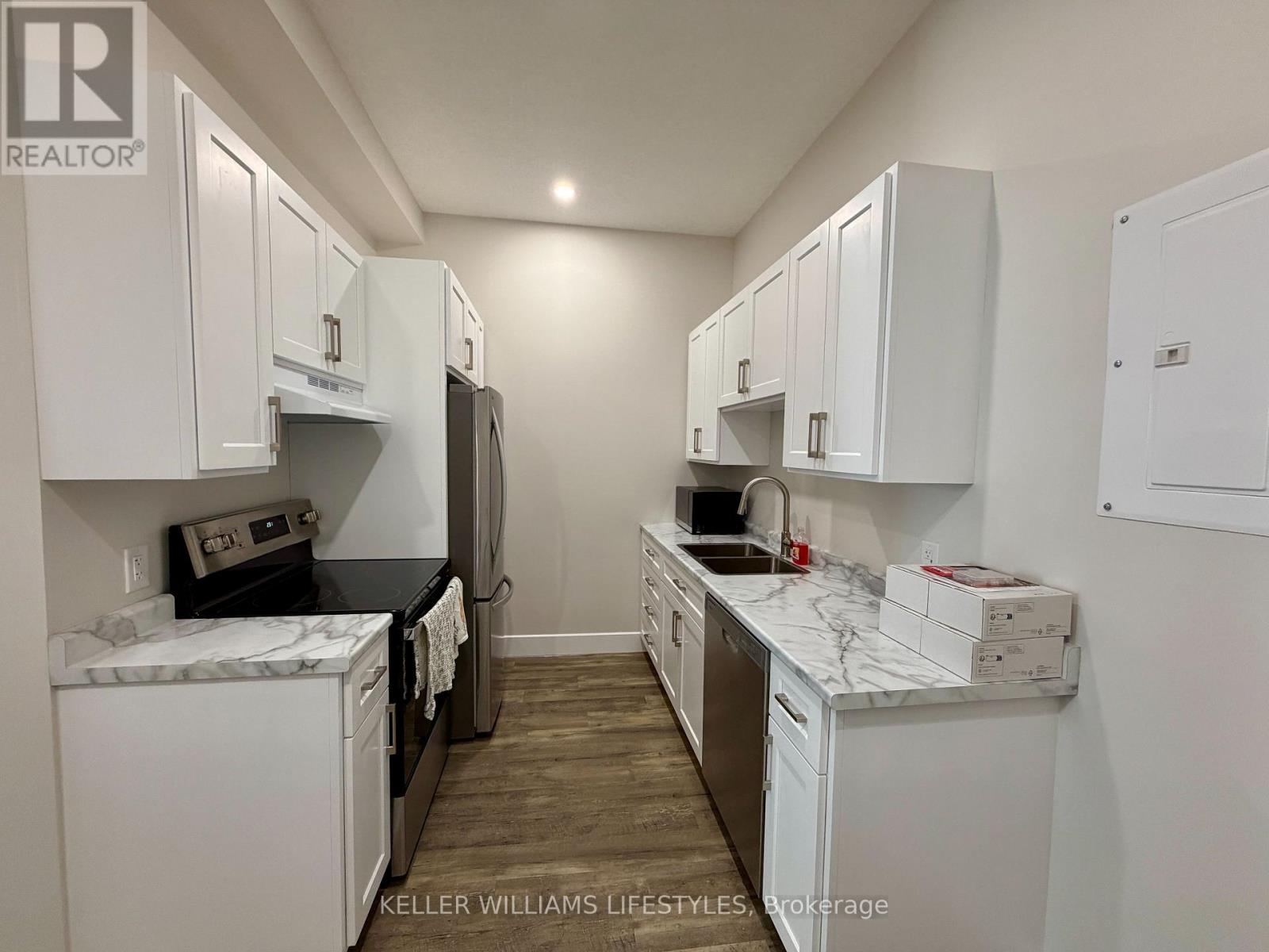A kitchen with white cabinets and appliances.