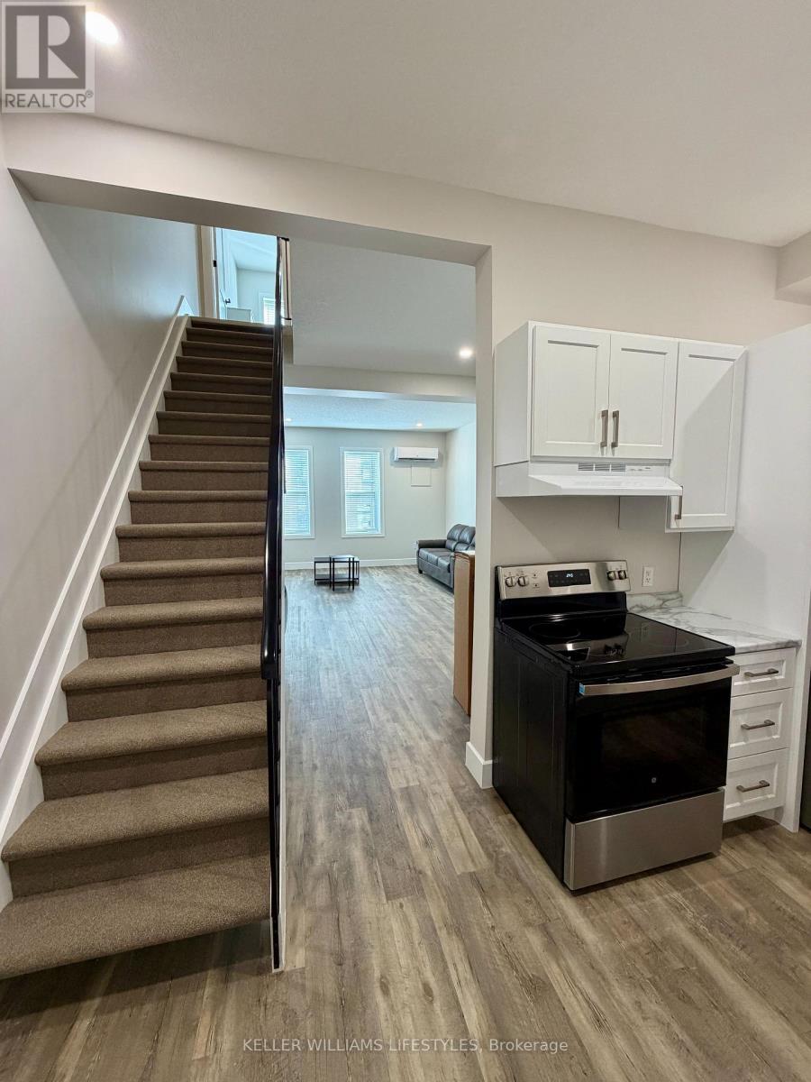 A kitchen with a stove and cabinets is shown in this image.