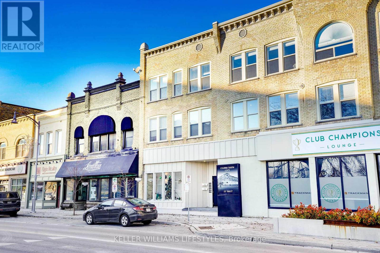 A street view of a building with the sign "CLUB CHAMPIONS LOUNGE" on the front.