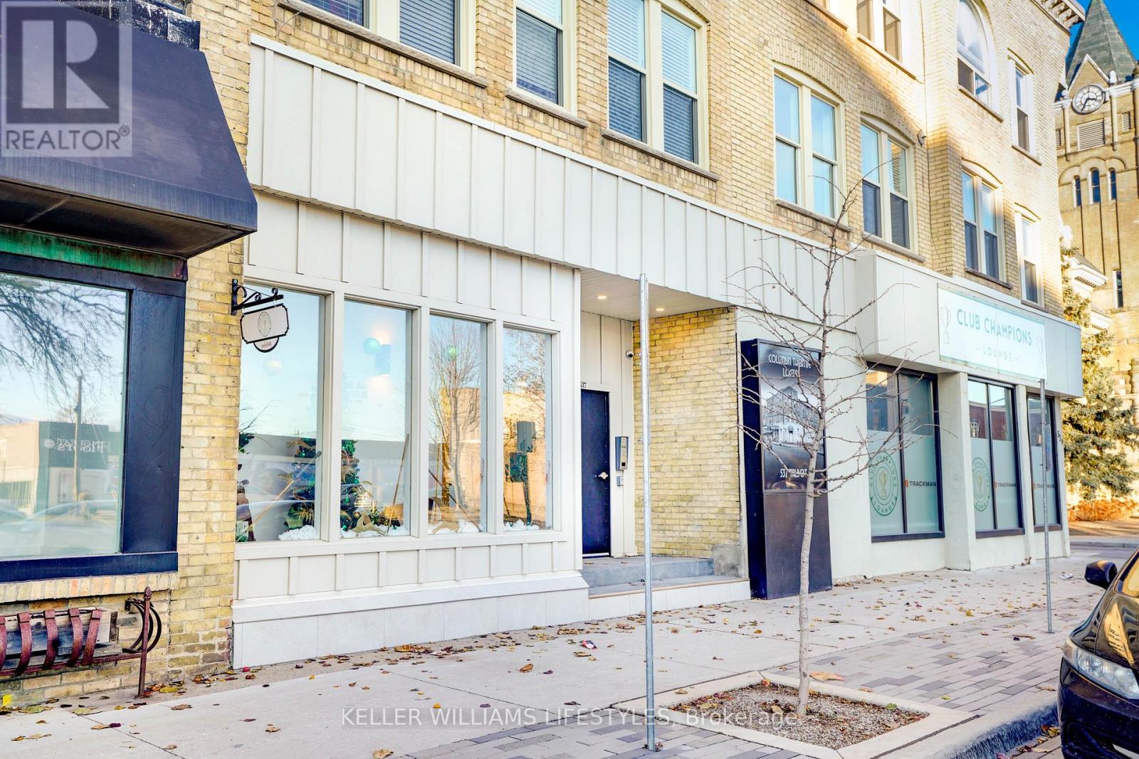 A building with a realtor sign on the corner.