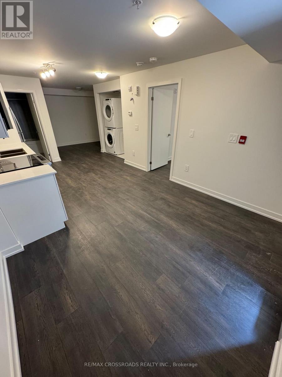 A room with a wood floor and white walls.