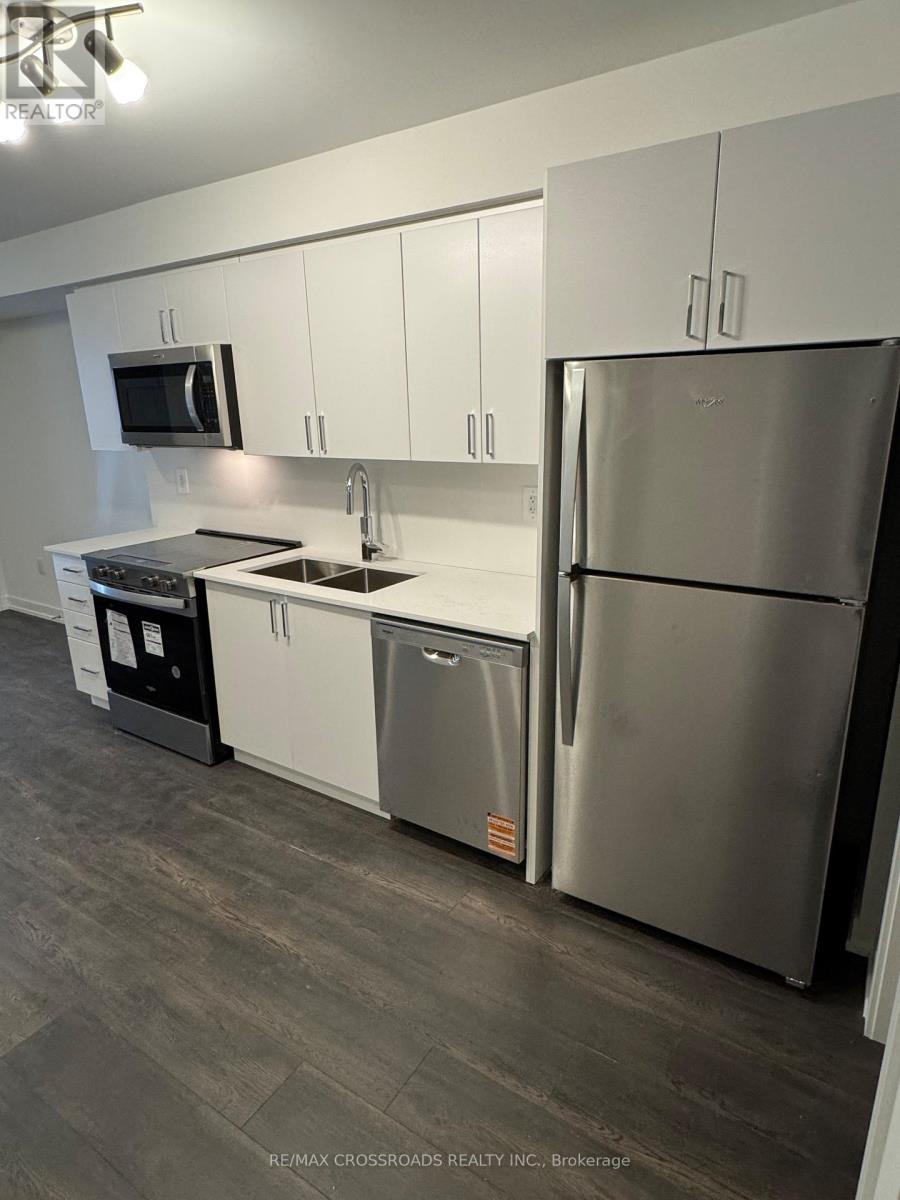 A modern kitchen with stainless steel appliances and white cabinets.