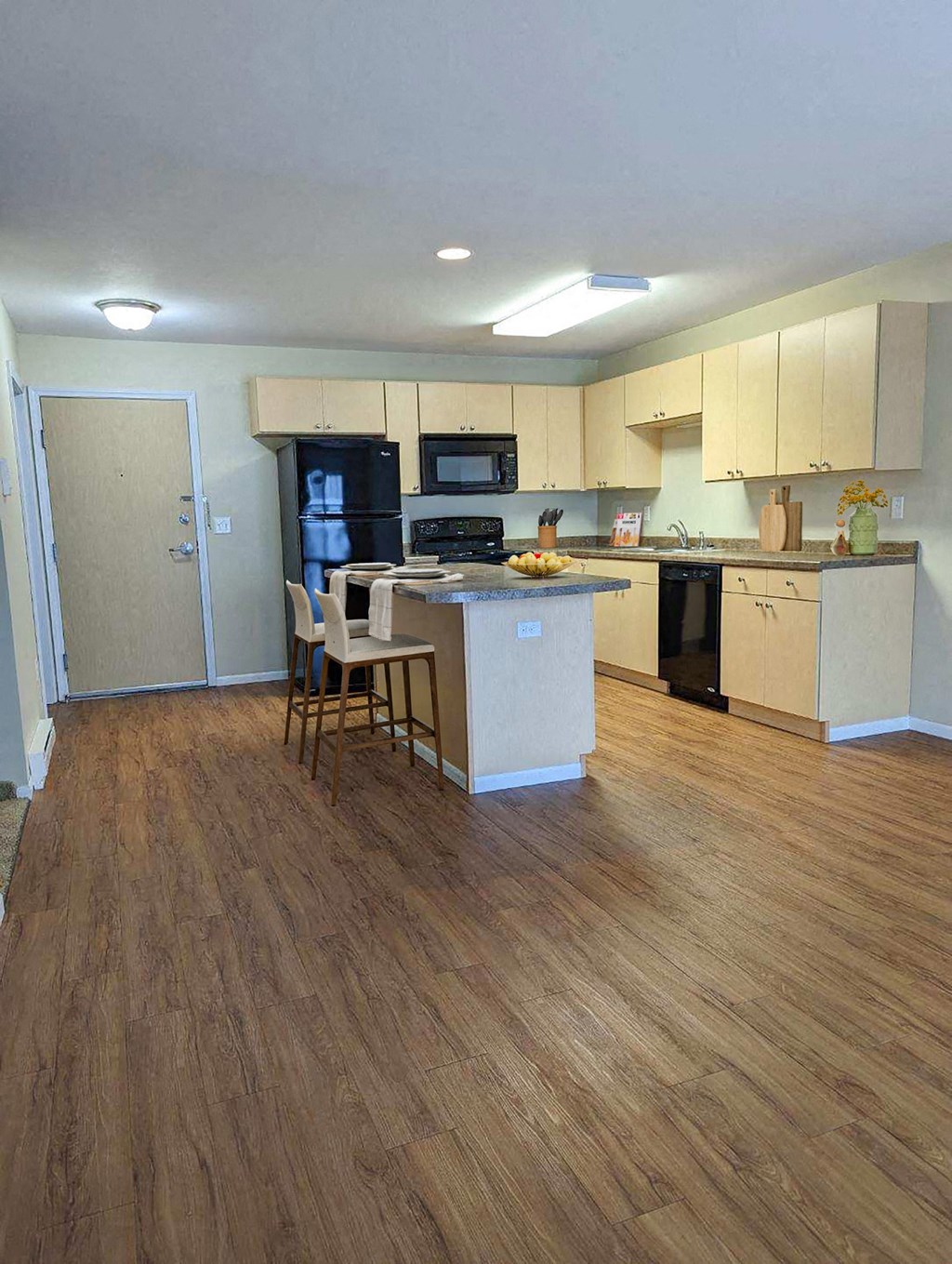 a kitchen with an island and a table with chairs