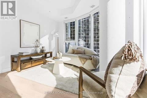 A living room with a white couch and a wooden coffee table.