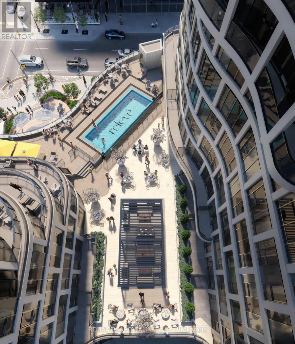 A modern building with a pool in the middle of a plaza.