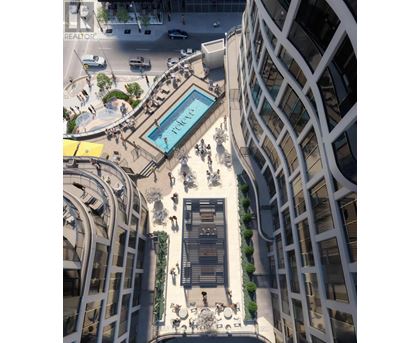 A modern building with a pool in the middle of a plaza.
