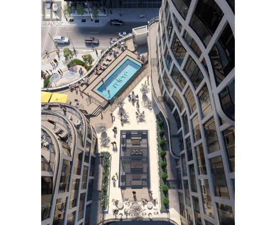 A modern building with a pool in the middle of a plaza.
