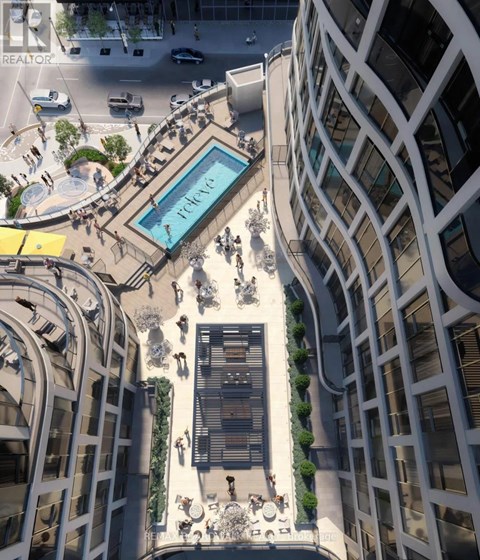 A modern building with a pool in the middle of a plaza.