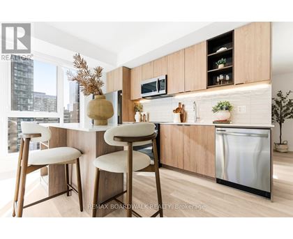 A kitchen with a white counter top and wooden bar stools.