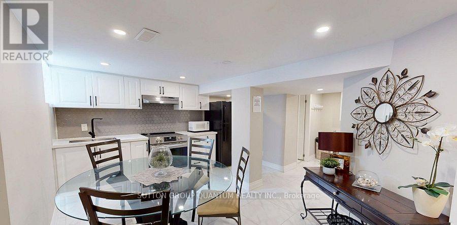 A modern kitchen with a glass table and chairs.