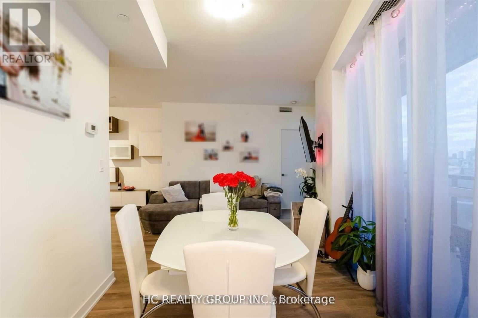 A dining room with a white table and chairs.