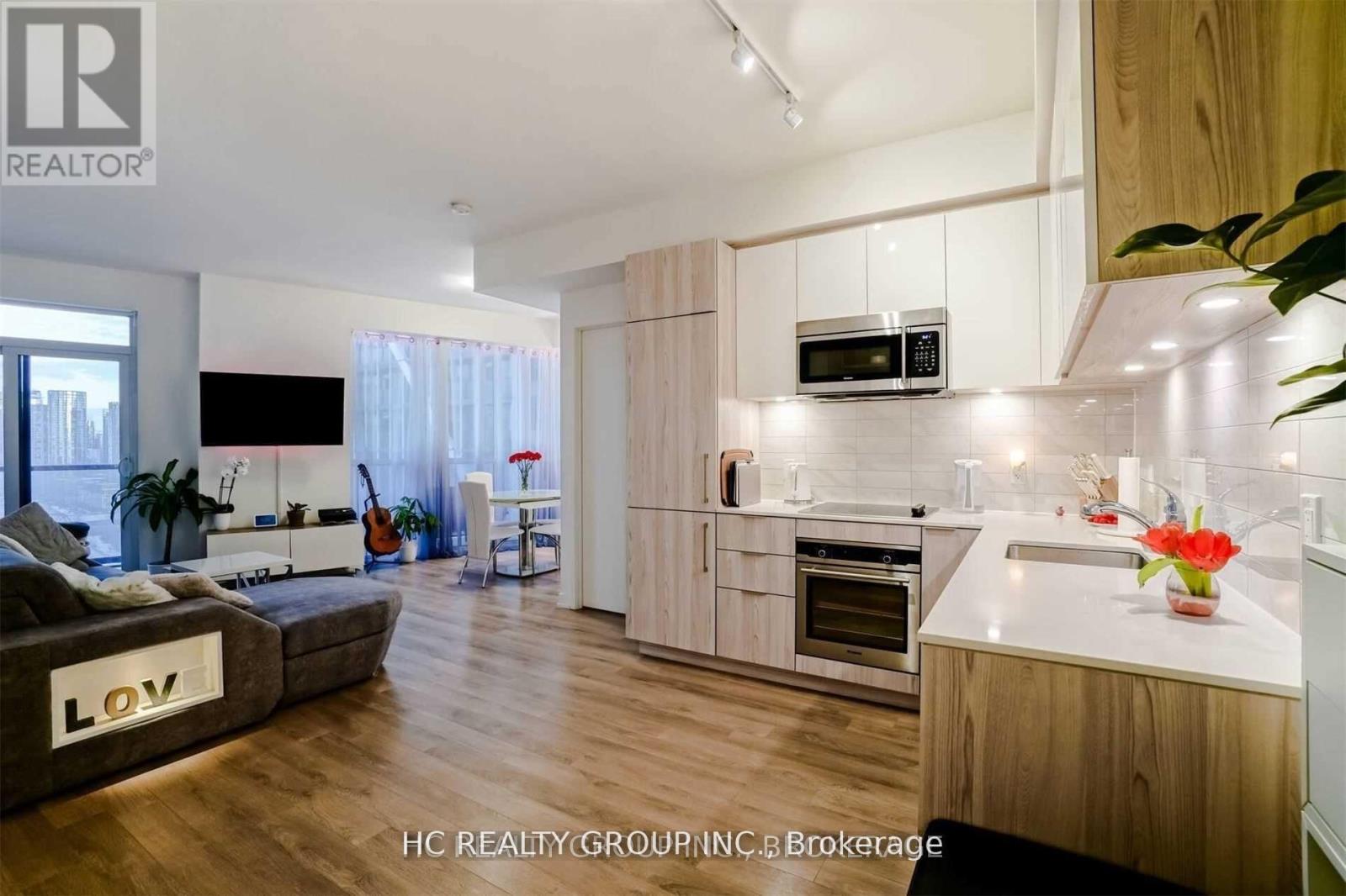 A modern kitchen with wooden cabinets and a white countertop.