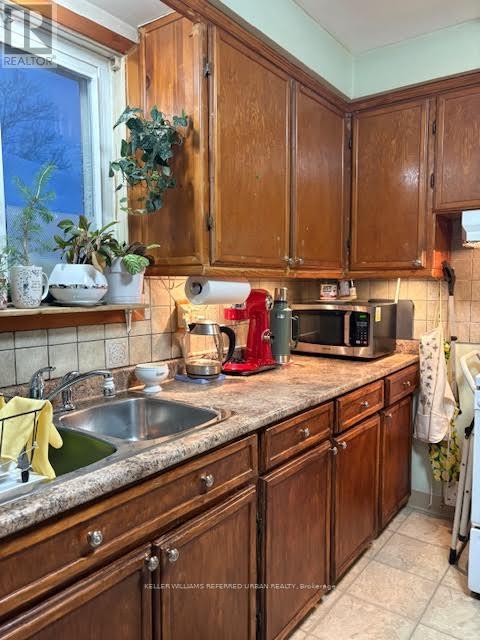 A kitchen with wooden cabinets and a granite countertop.