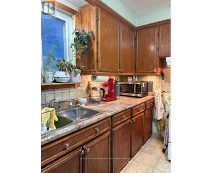A kitchen with wooden cabinets and a granite countertop.