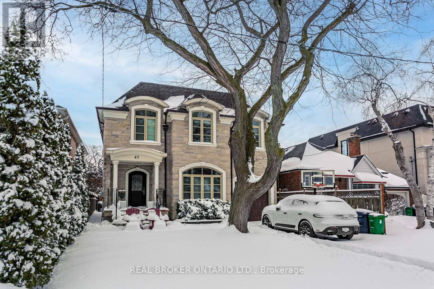 A house with a car parked in front of it.