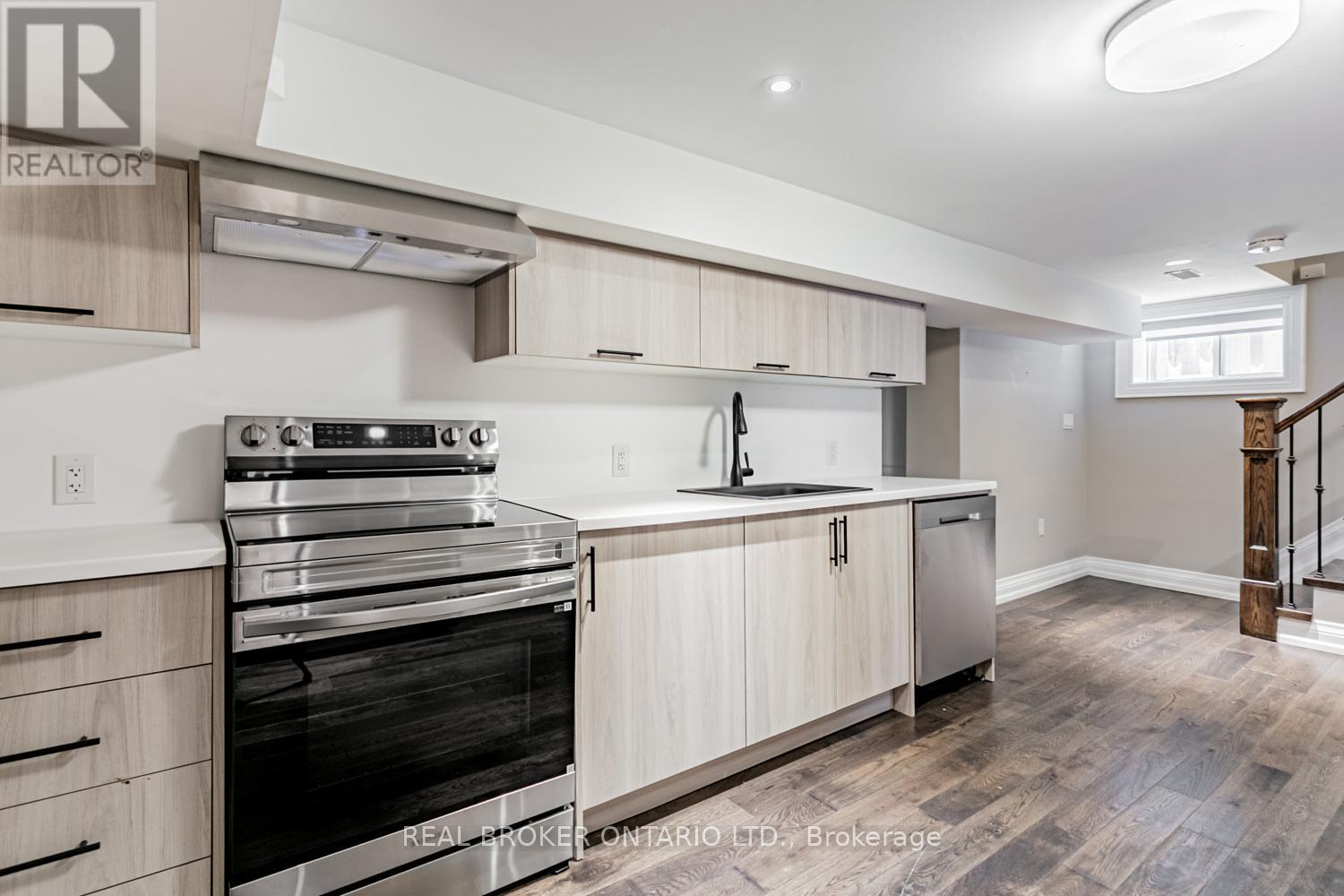 A modern kitchen with wooden cabinets and stainless steel appliances.