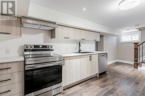 A modern kitchen with wooden cabinets and stainless steel appliances.
