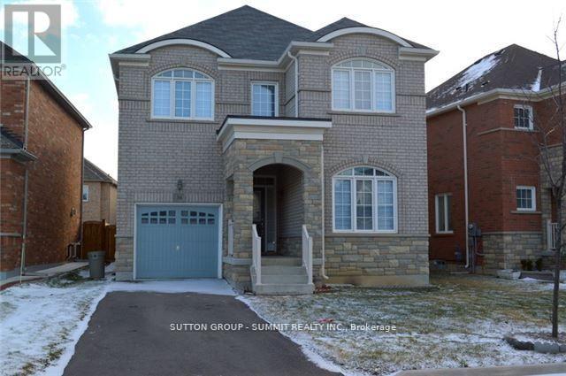 A house with a grey garage door is for sale.