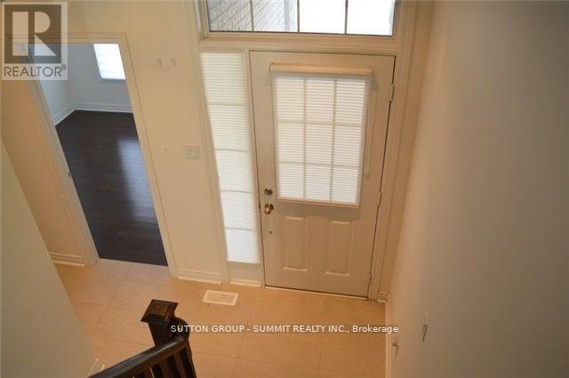 A hallway with a door and a window with blinds.
