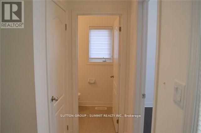 A hallway with a door on the left and a window on the right.