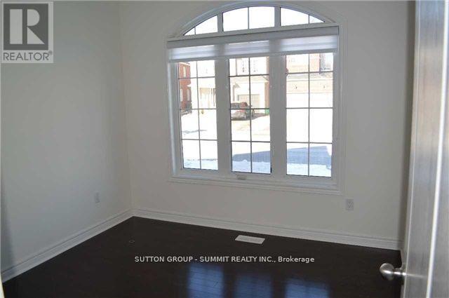 A room with a large window and a white wall.