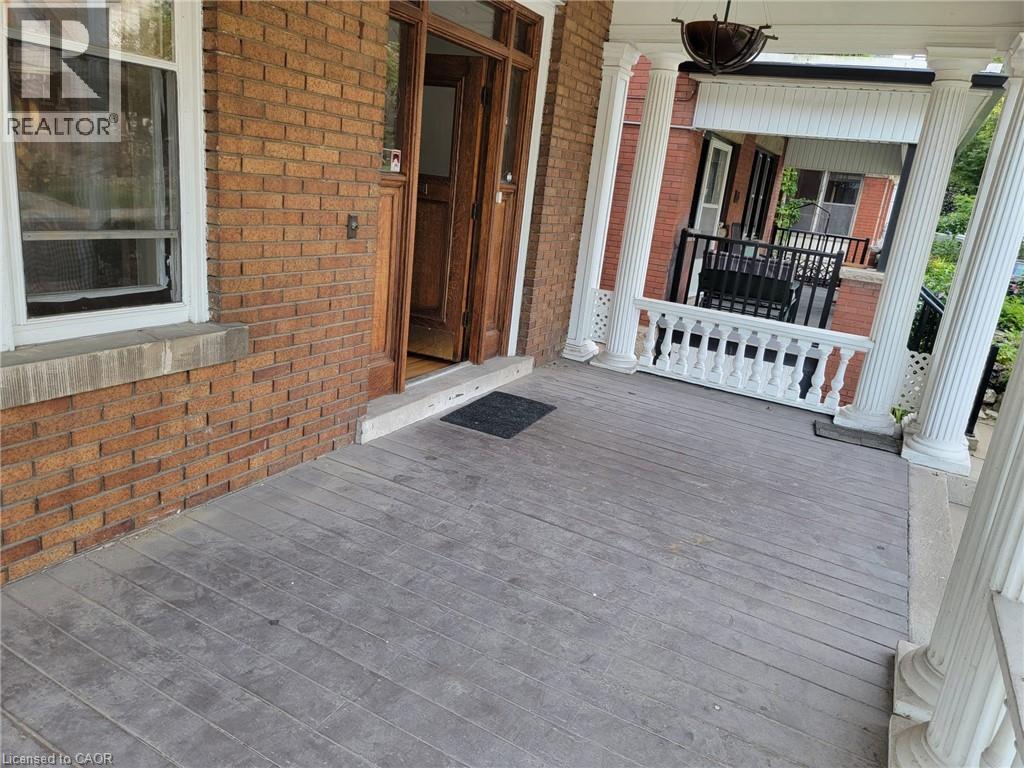 A porch with a grey floor and a white railing.