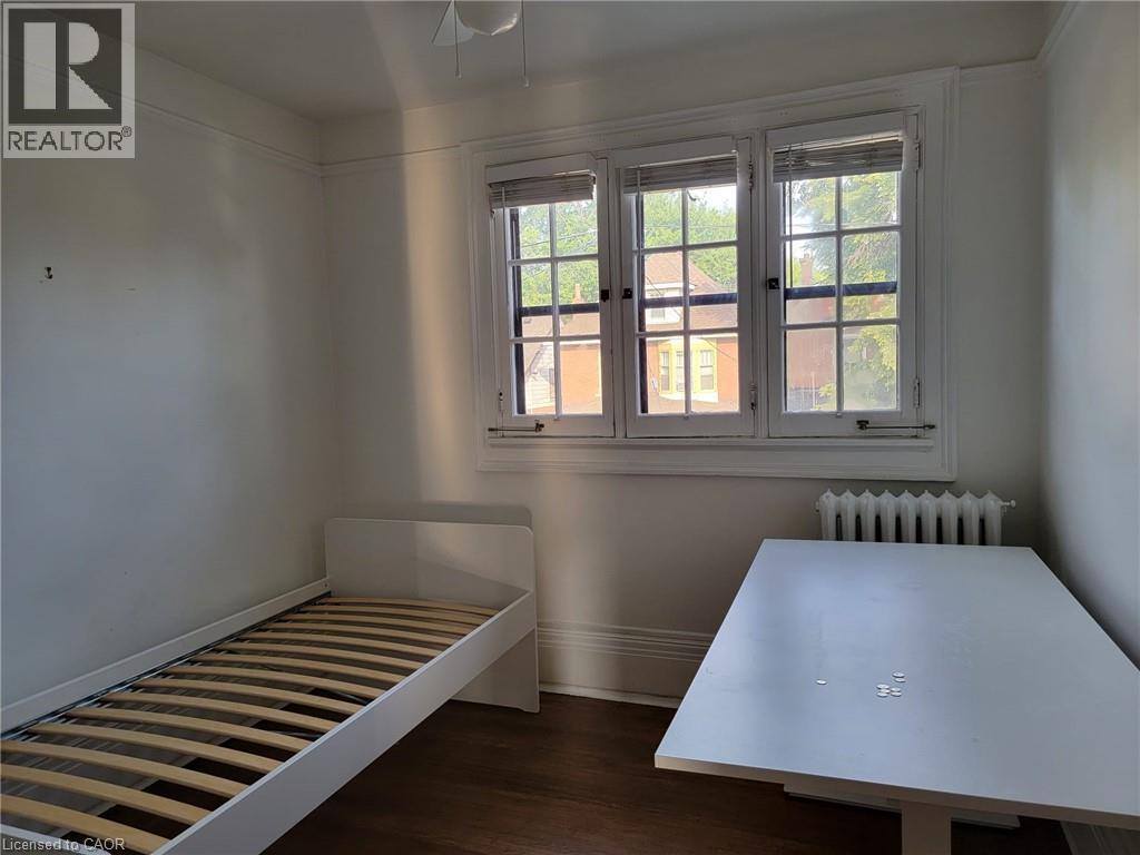 A bedroom with a bed and a table.