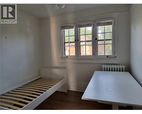 A bedroom with a bed and a table.