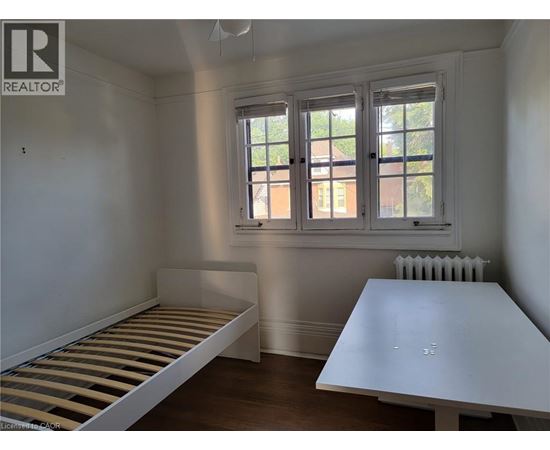 A bedroom with a bed and a table.