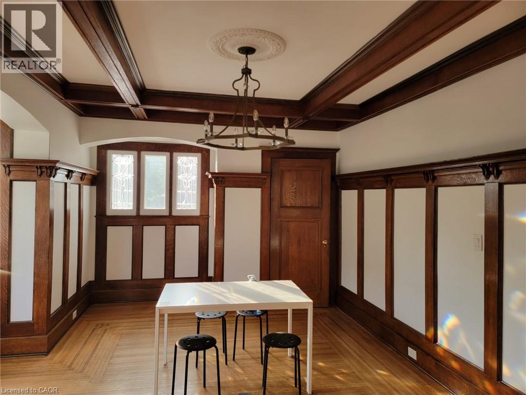 A dining room with a table and chairs.