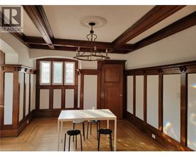 A dining room with a table and chairs.