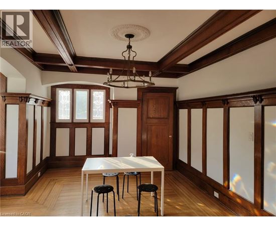 A dining room with a table and chairs.