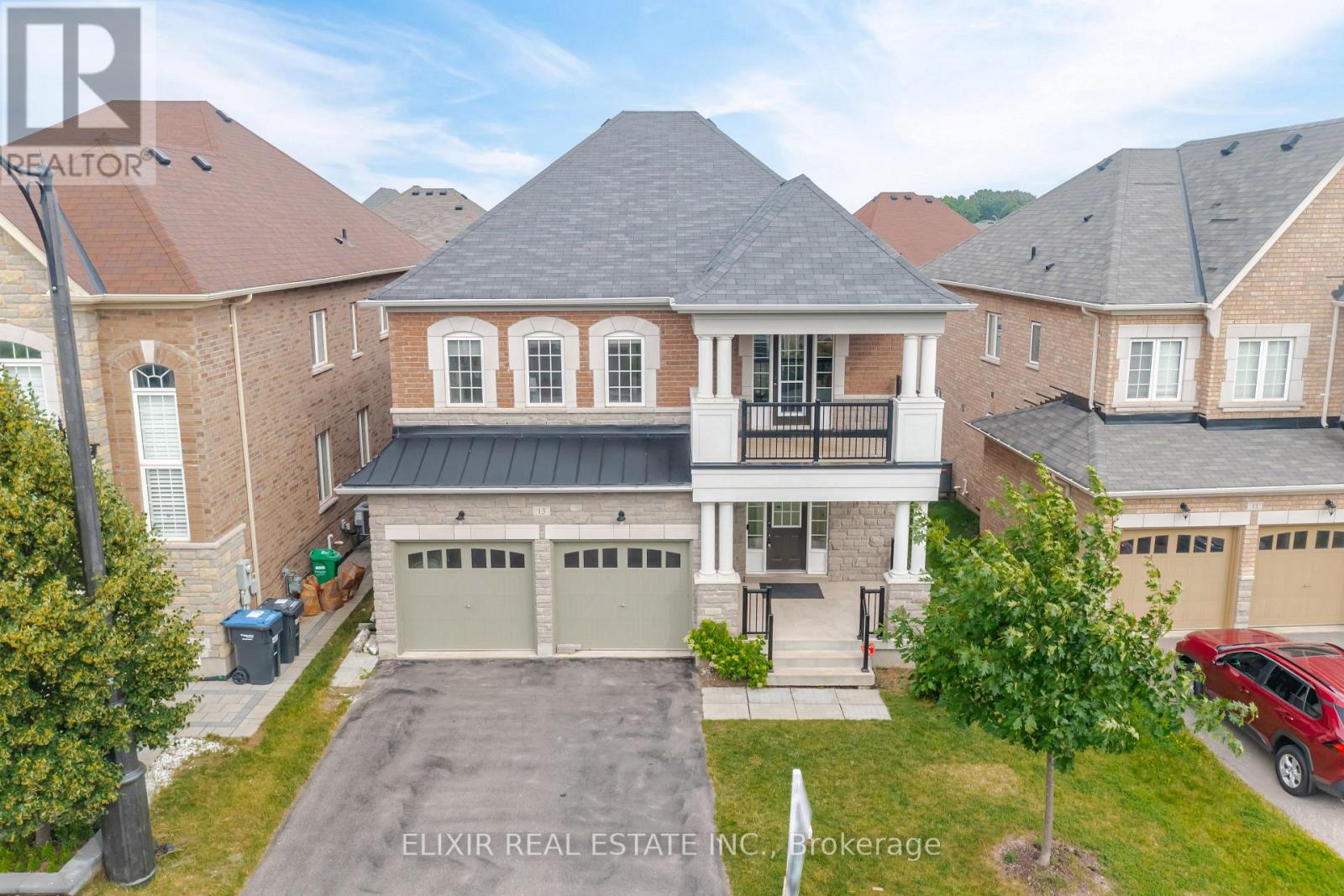 A real estate company is advertising a property with a large front yard and a two-car garage.
