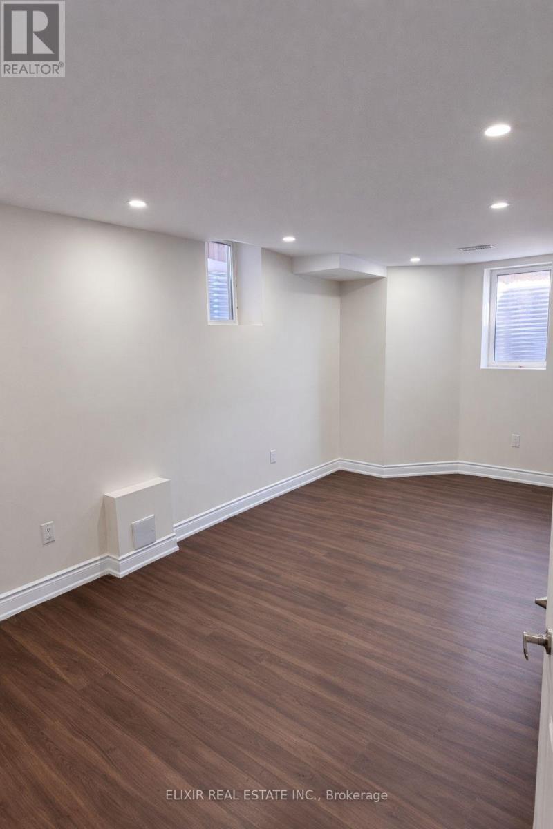 A room with wooden flooring and white walls.