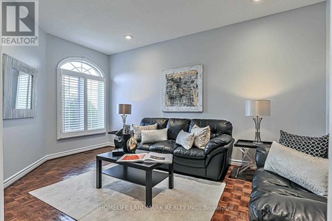 A living room with a black couch and a coffee table.