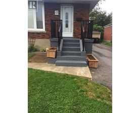 A house number 17 with a white door and a black railing.