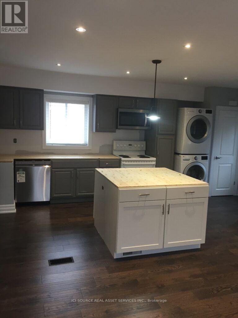 A kitchen with a white cabinet and a window.