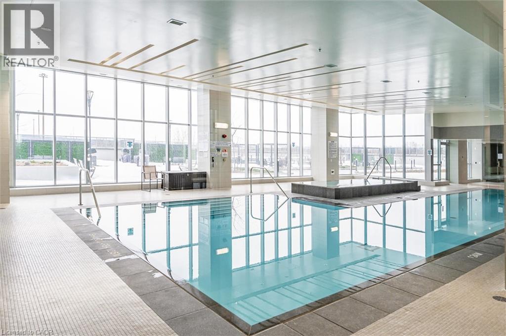 A large indoor swimming pool with a glass wall.