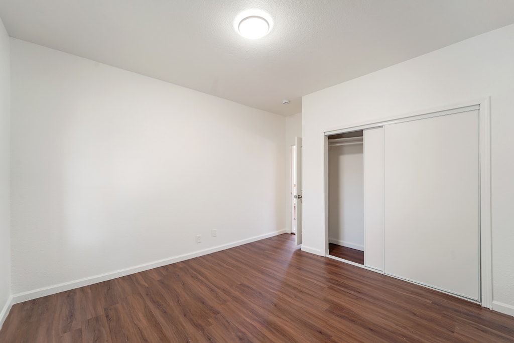 A room with wooden floors and white walls.