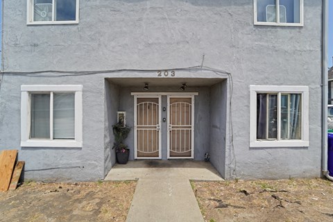 A grey house with the number 203 on the front.